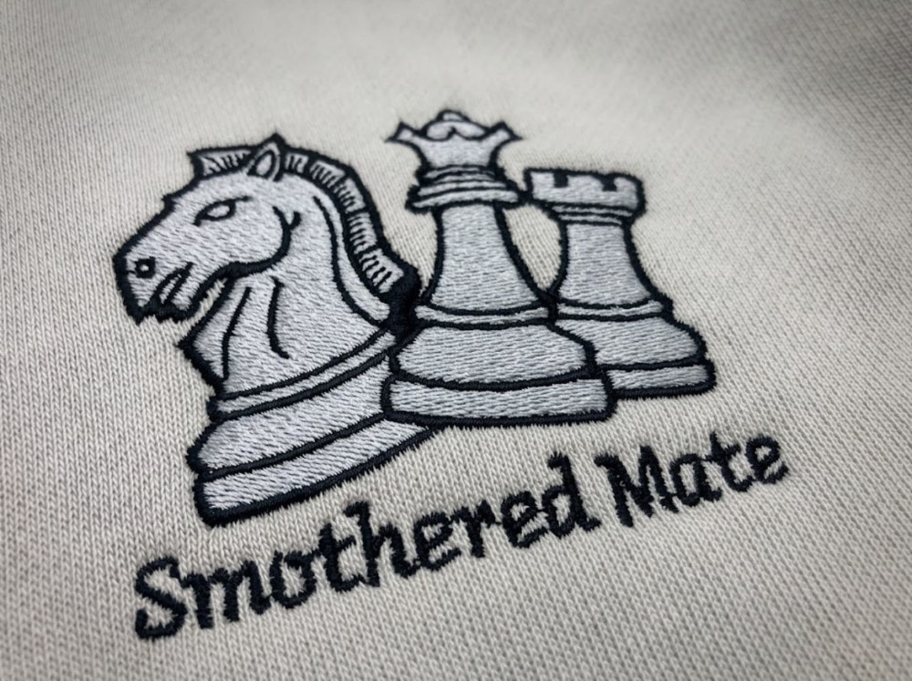 Smothered Mate knight, queen and rook embroidered streetwear hoodie embroidery close-up view