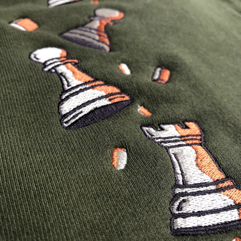 Olive Pawn Chip Sweatpants by Smothered Mate - closeup view of embroidery