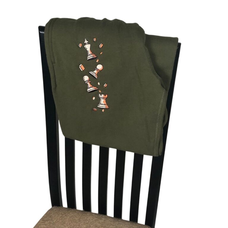 Olive Pawn Chip Sweatpants by Smothered Mate folded over a chair